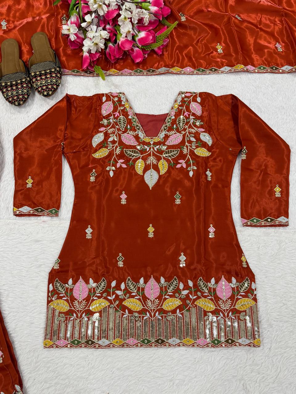Elegant Rust Orange Silk Kurta and Flared Palazzo Set Adorned with Intricate Multicolored Botanical Embroidery and Mirror Work